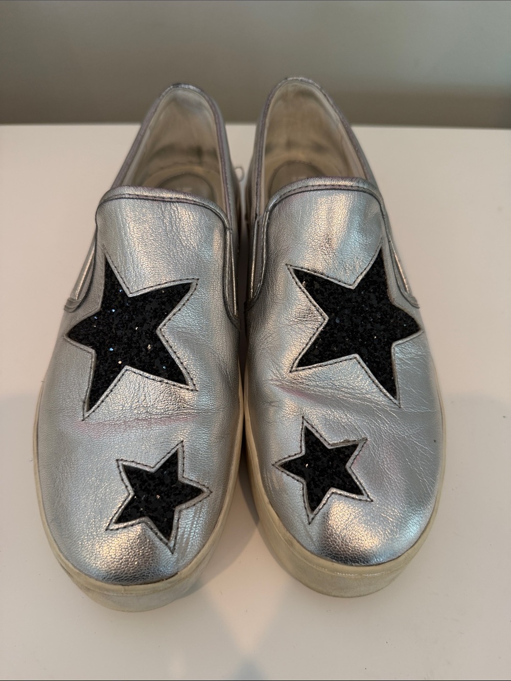 MICHAEL Michael Kors Silver Slip-On Sneakers with Black Star Appliqués